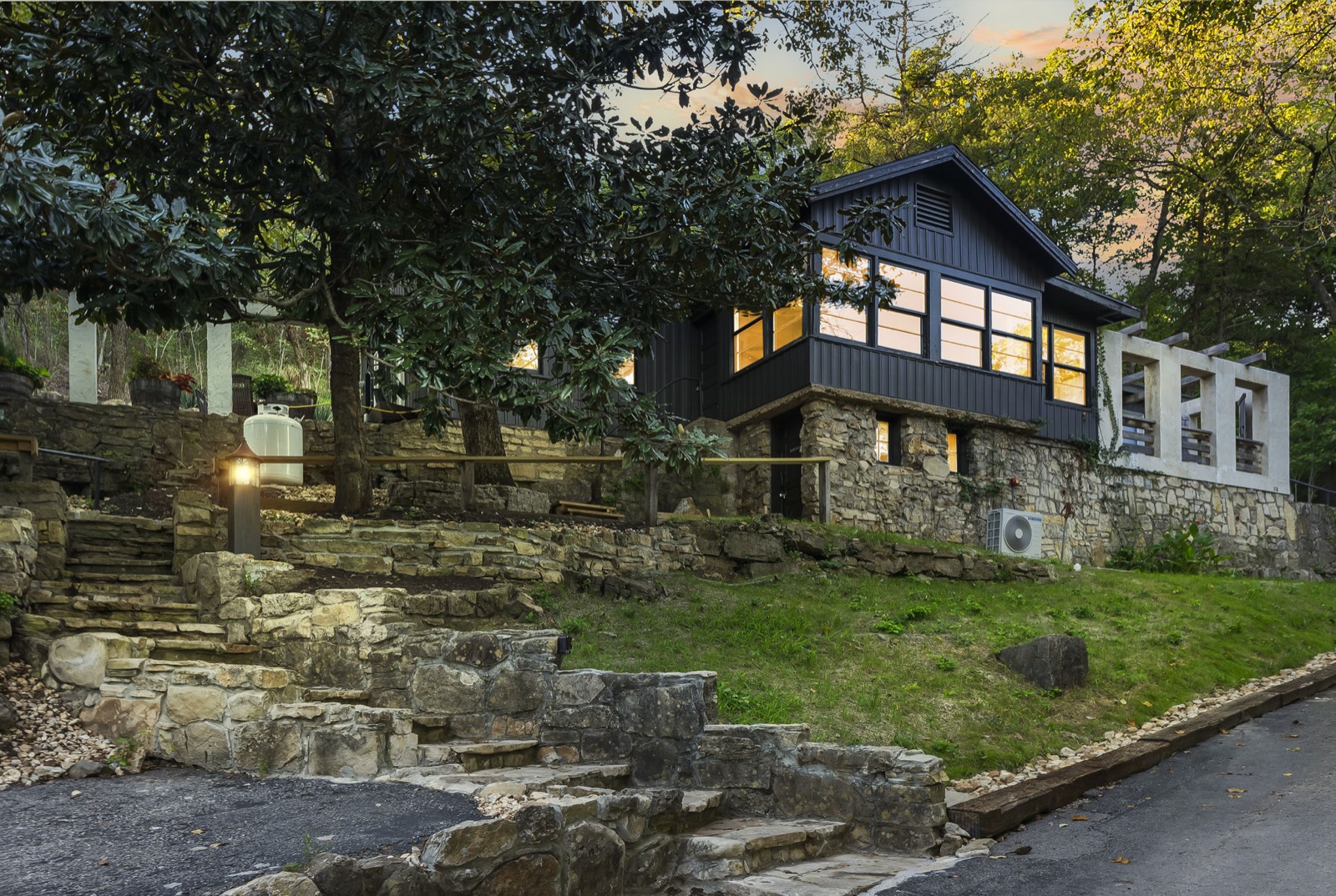 Dusk exterior of a stone-and-wood Branson rental
