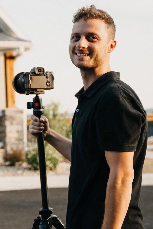 A Watson Media House photographer on site with a camera and tripod
